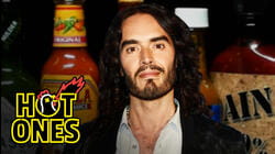 Russell Brand Serenades Superfan Brett Baker While Eating Spicy Wings | Hot Ones