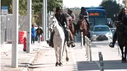 Men riding horses through streets of downtown Durham: VIDEO