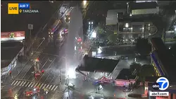 Sheared hydrant sends geyser of water shooting into air next to Tarzana gas station