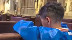 See Young Fan Put in a Prayer for the NY Knicks at St. Patrick's