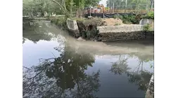 Discolored water flowing into Nissequogue River after contractor struck an underground spring in Smithtown