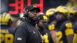 Fired University of Michigan football coach charged with home invasion, stalking