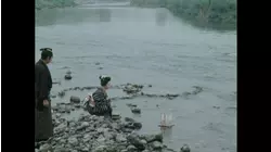 Woman setting lanterns adrift