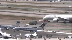Passengers evacuate by slides after engine fire on United flight at LAX