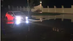 Cars drive through several inches of standing water in Brentwood