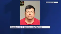 Man faces charges for breaking into 2 Greenwich homes, 2nd suspect at-large