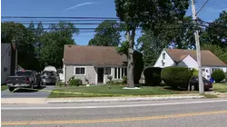 Car crashes into utility pole in Amityville, temporarily knocks out power
